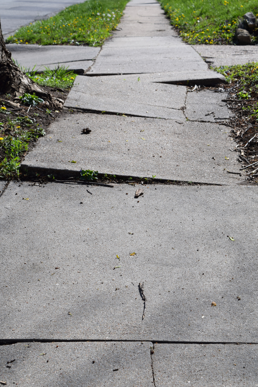 Damaged Concrete Sidewalk Needs Repair